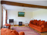 Large sitting room with french doors leading to patio